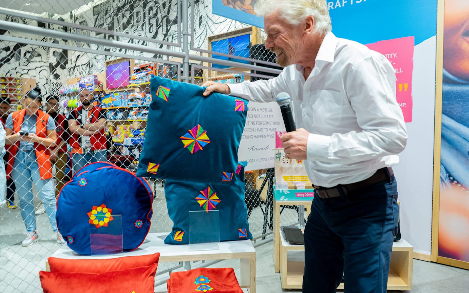 Richard Branson at Virgin Megastores holding a pillow from Made51