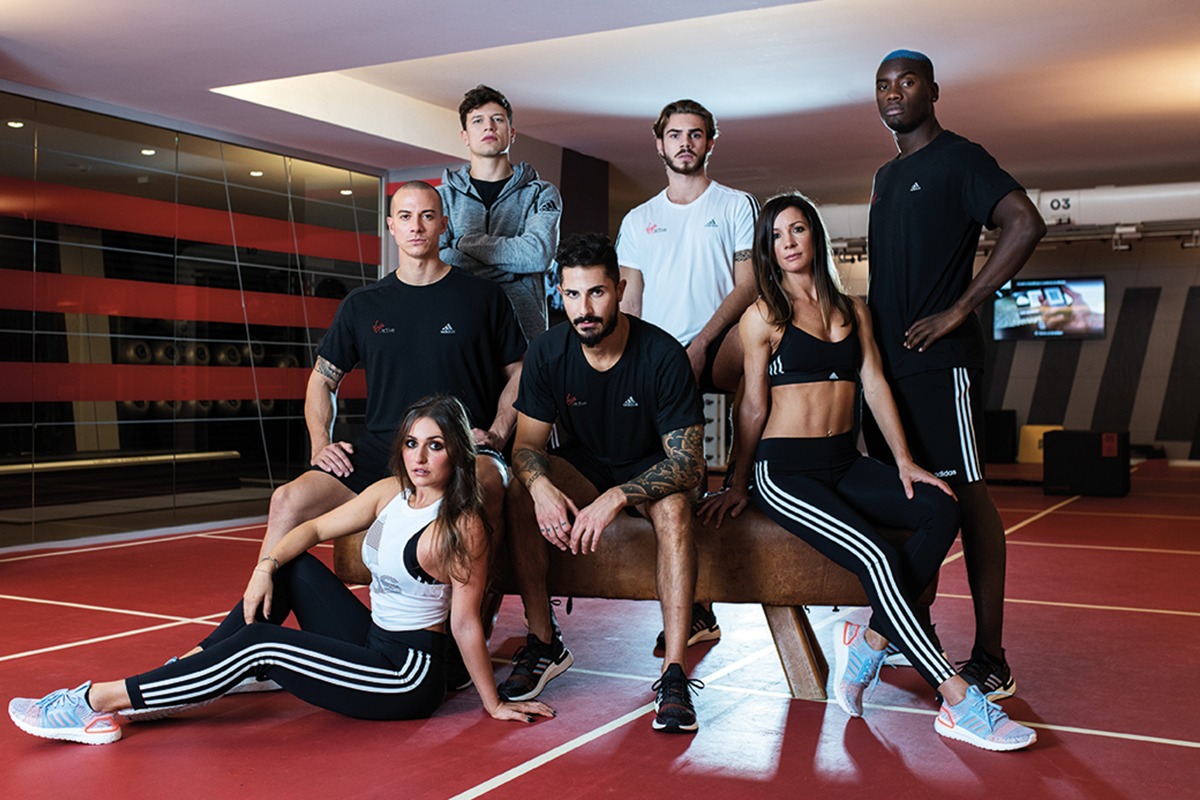 Group of people in workout gear posing for a photo