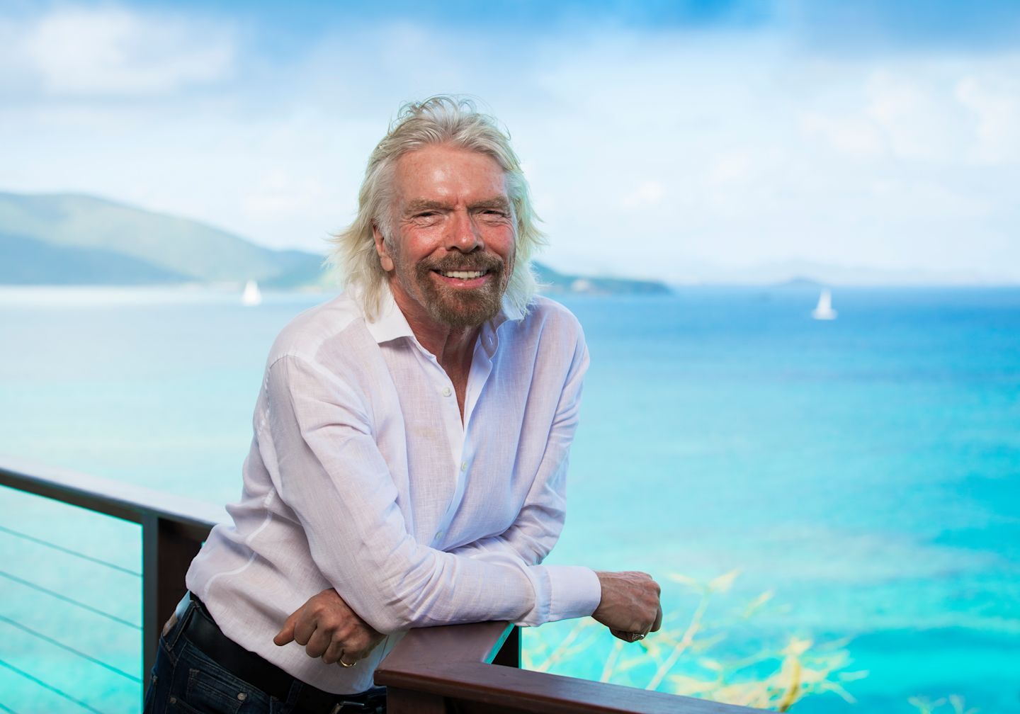 Richard Branson smiling next to the ocean