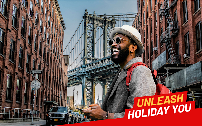 An image of a man stood under Brooklyn Bridge An image of a man stood under Brooklyn Bridge