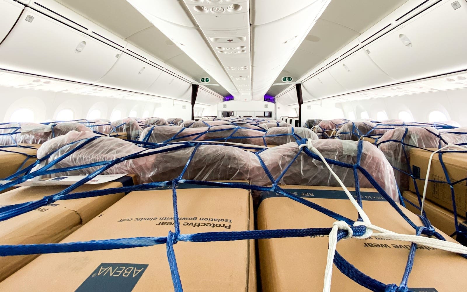 picure of boxed protective wear in the cargo area of a virgin plane ready for transport to help provide supplies for covid19
