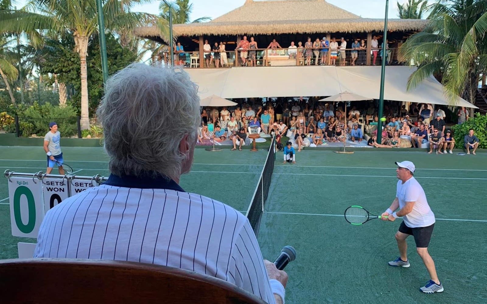 richard Branson watching a tennis match at the 2019 Necker Cup