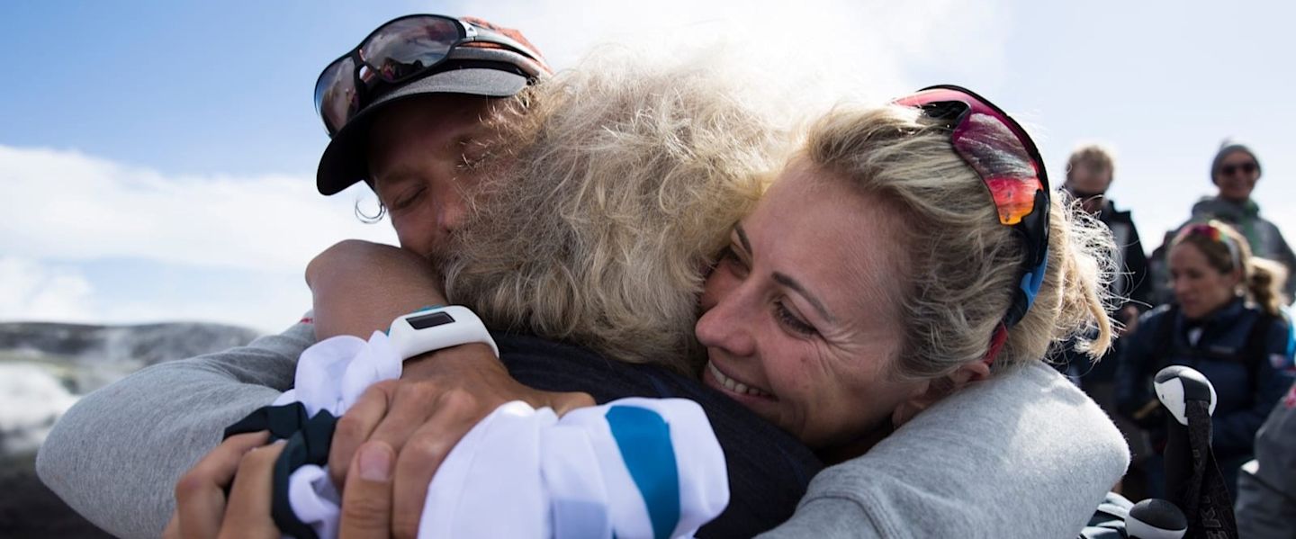 Richard Branson hugging a family