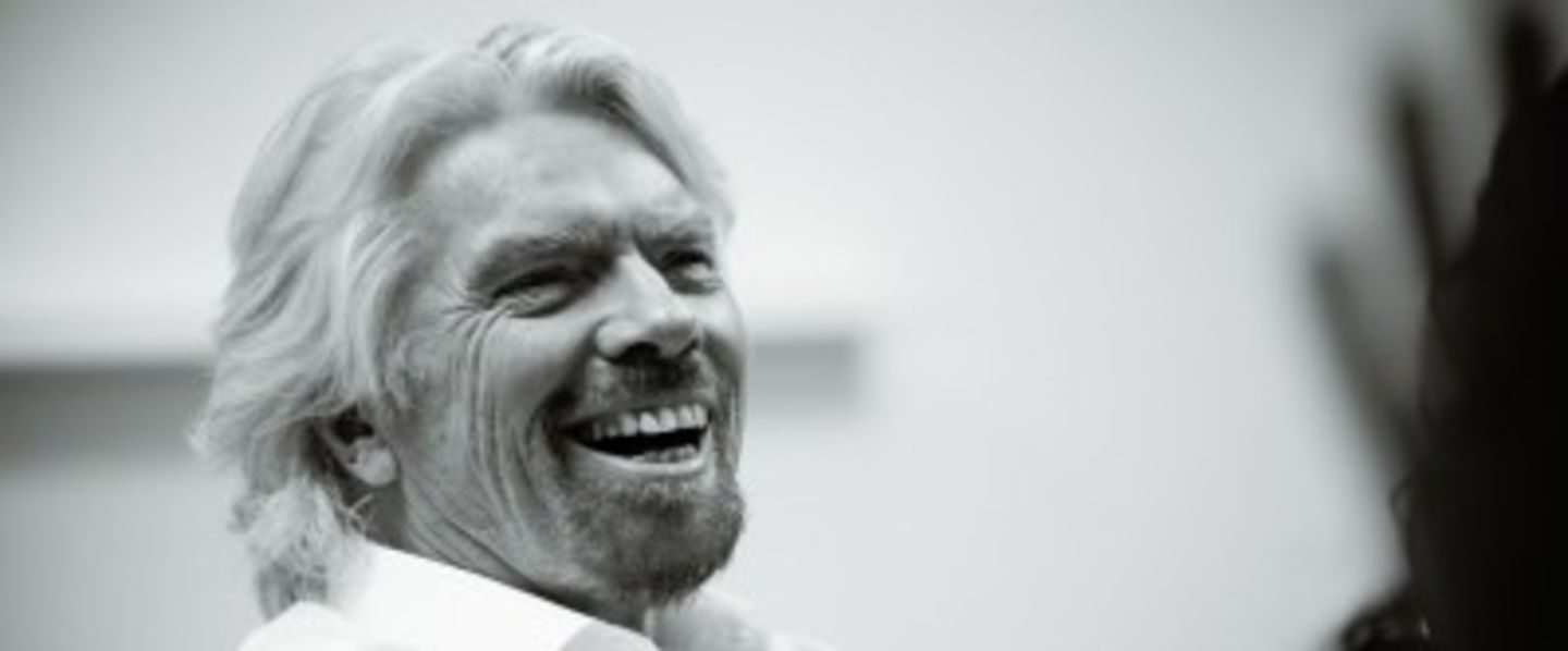 Black and white image of Richard Branson laughing