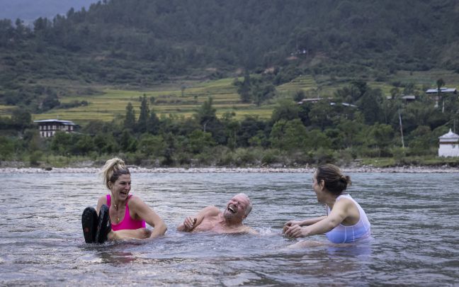 Richard Branson laughing in a lake in Bhutan