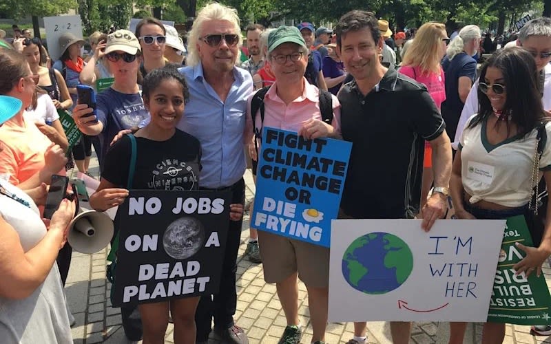 Richard Branson with a group of people on the climate march