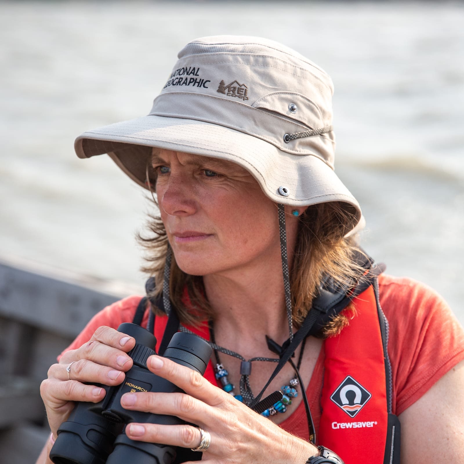 Heather Koldewey wears a sunhat and holds binoculars