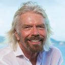 A close up of Richard Branson smiling, looking at the camera