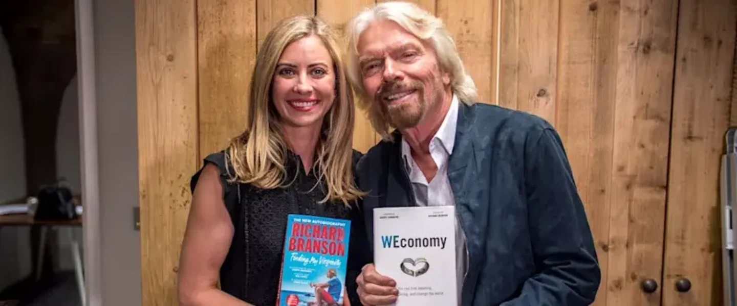 Holly Branson and Richard Branson holding copies of Finding My Virginity and WEconomy