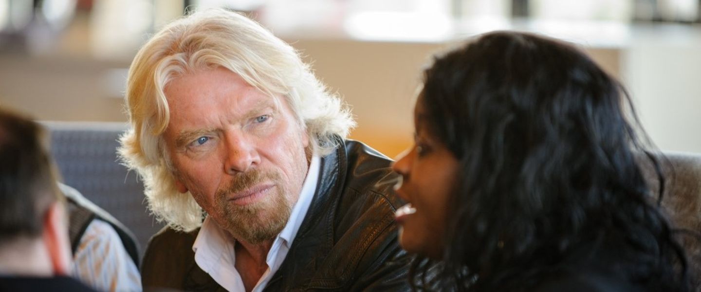 Richard Branson speaking to an employee at the Battleship office in London