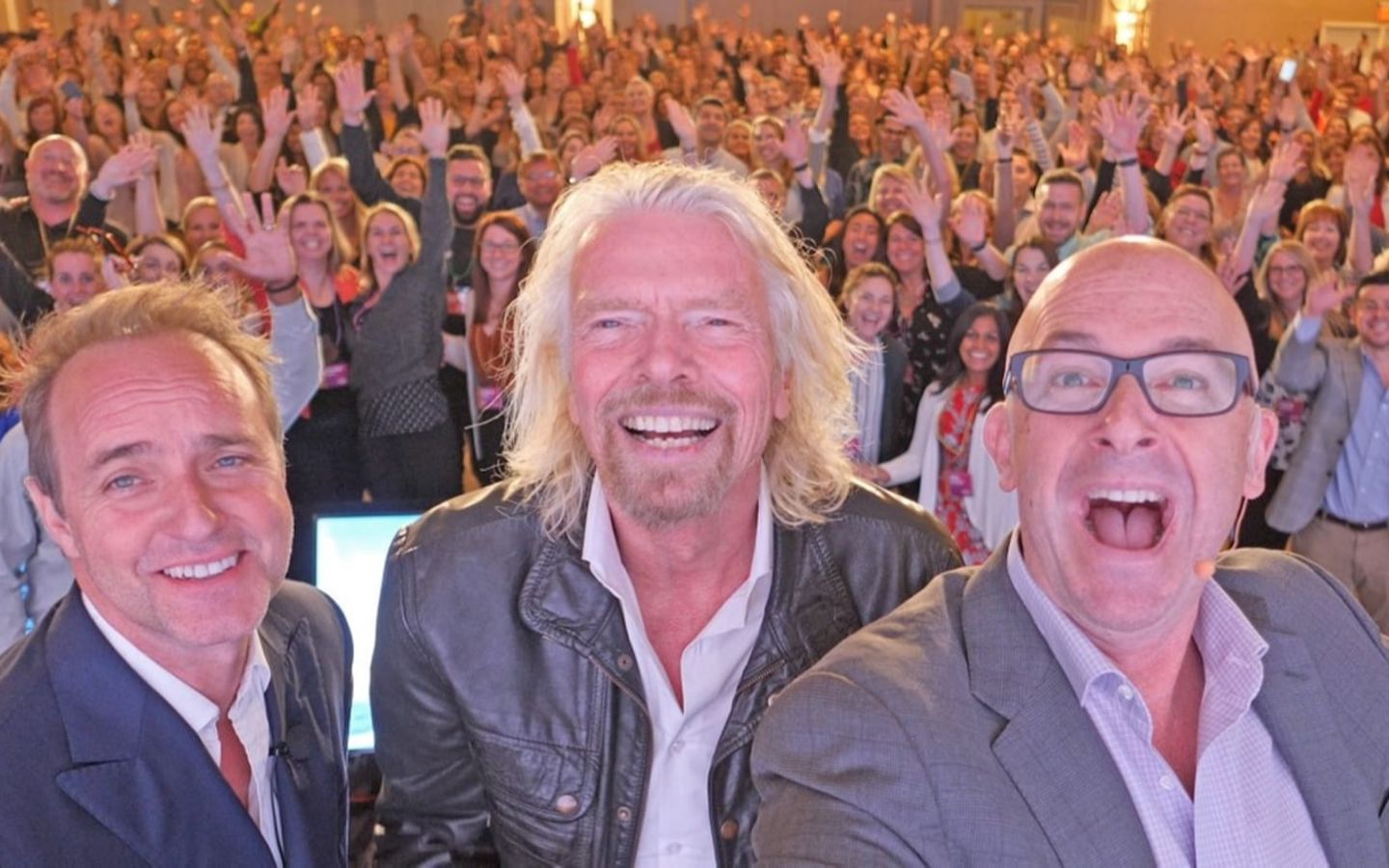 Dave Osborne, Richard Branson and Mark Jeffries take a selfie on stage at the Virgin Pulse Thrive Summit in New Orleans