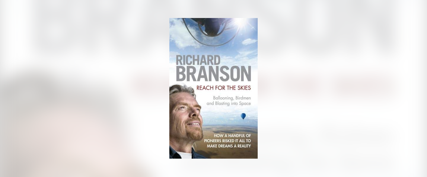 Front cover of Reach for the Skies by Richard Branson. He is looking towards the sky and there is a hot air balloon in the distance