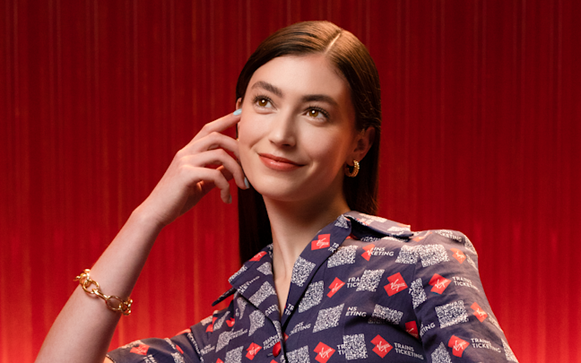 A woman in a Virgin Trains Ticketing jumpsuit A woman in a Virgin Trains Ticketing jumpsuit