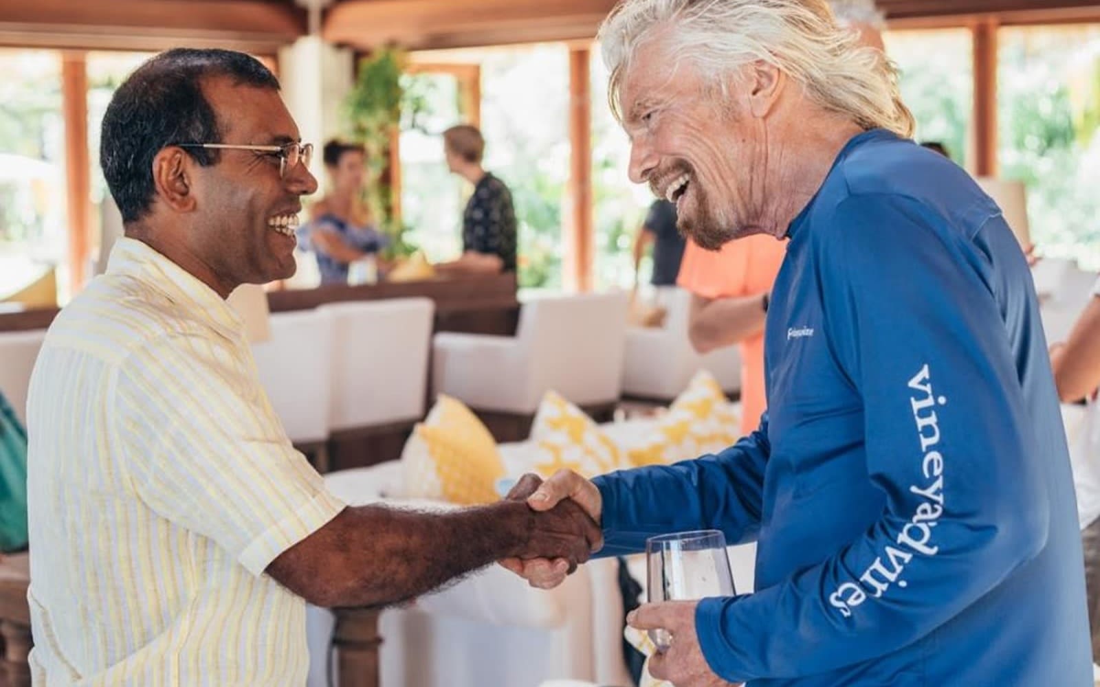 Richard Branson shaking hands with Mohamed Nasheed, smiling at each other