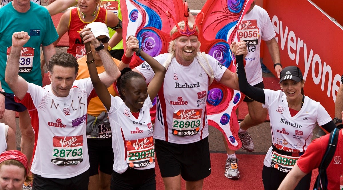 Richard Branson celebrates crossing the finishing line of the Virgin London Marathon