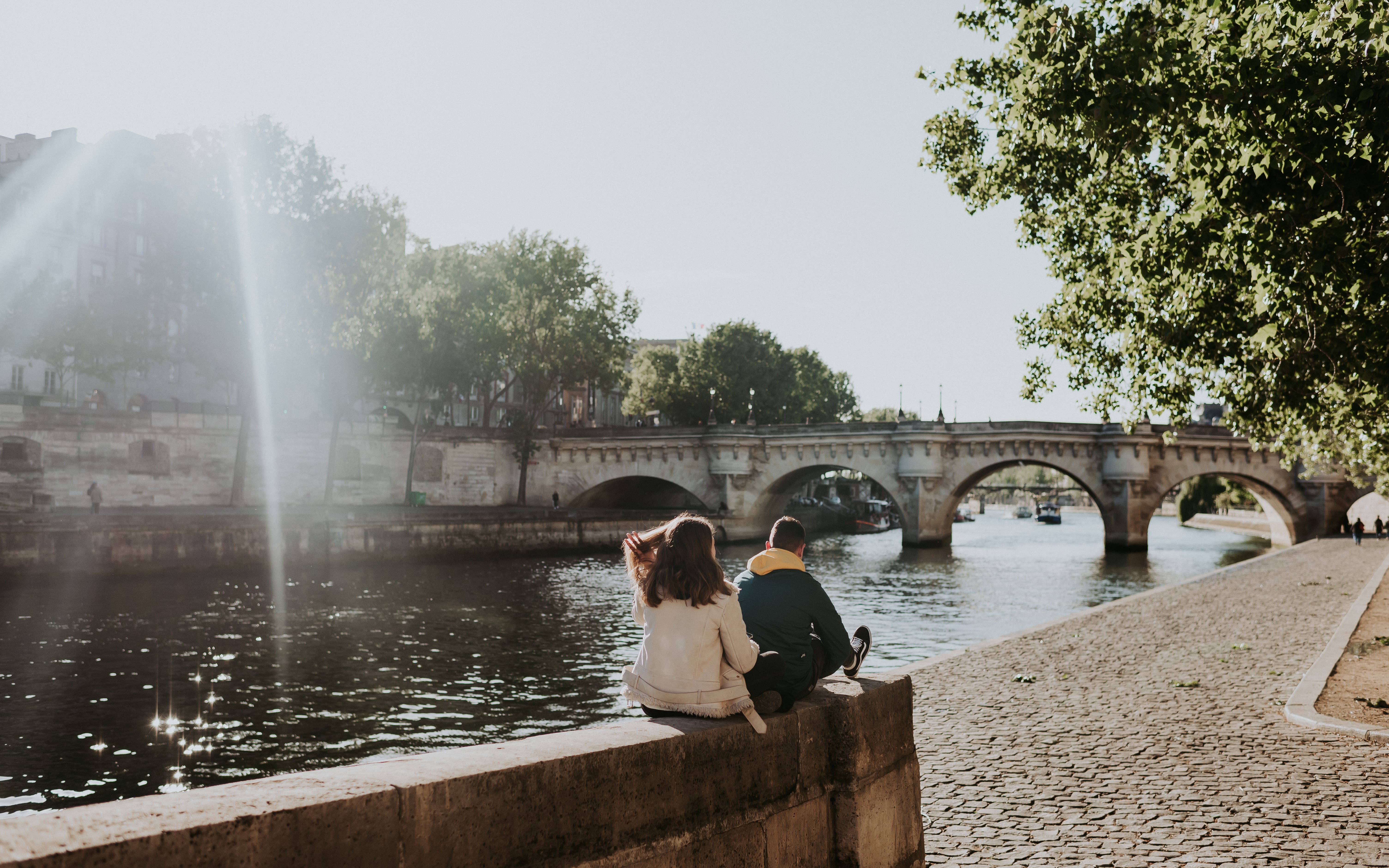 Image of a couple looking towards the river in Paris. 