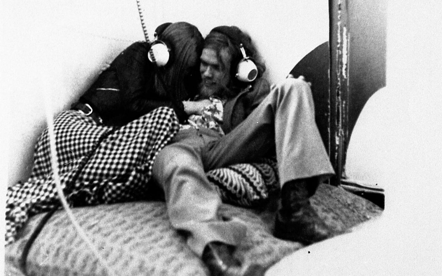 a young Richard Branson listening to music with headphones on in a Virgin Records store