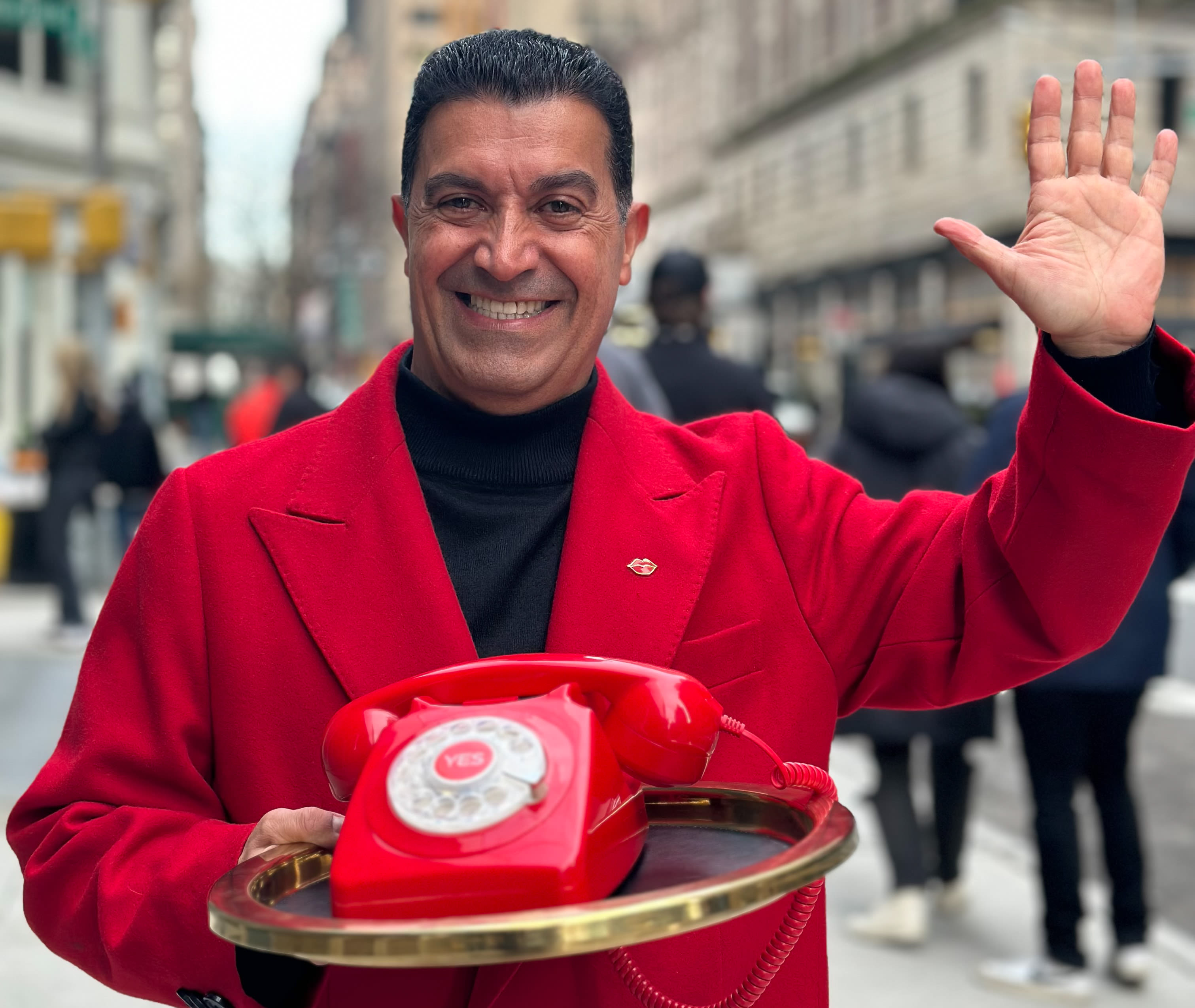 Virgin Hotels New York City doorman holding a gold tray with a red phone with the word "YES!" written on it