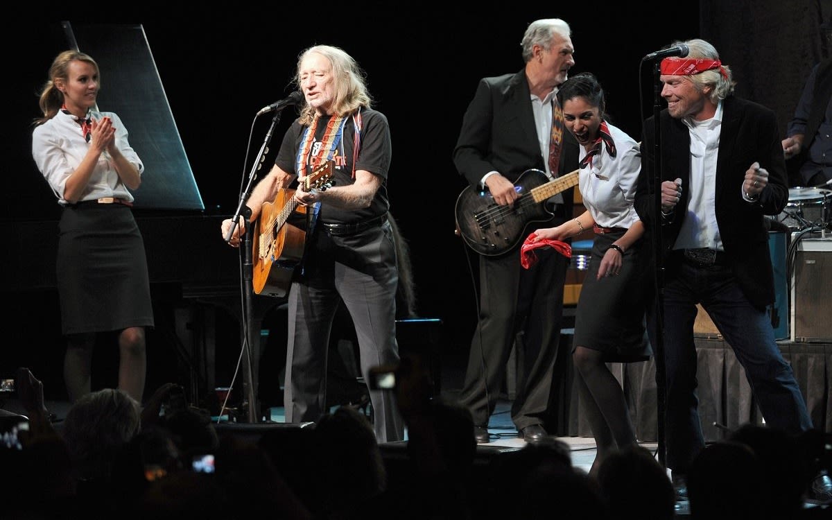 Richard Branson dancing on stage with Willie Nelson at the Dallas Winspear Opera House