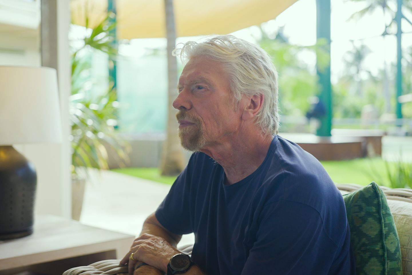 Richard Branson looking into the distance on Necker Island