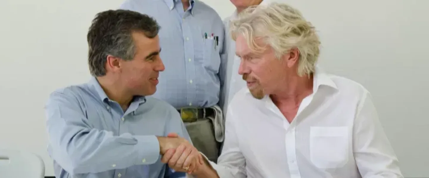 Richard Branson shaking hands with a man.