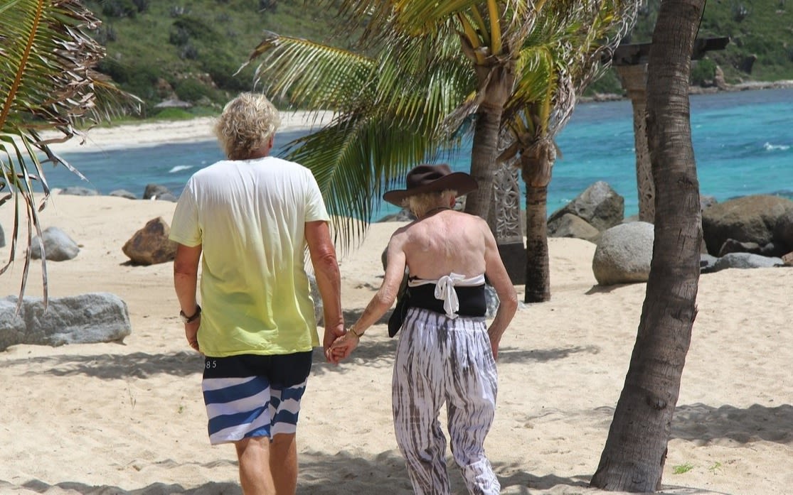 Richard Branson and mum Eve walking on the beach on Necker Island