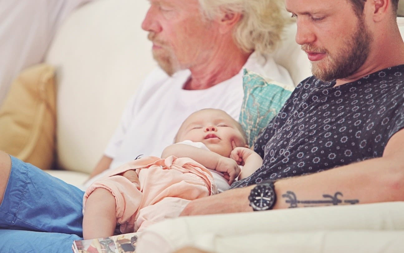 Richard Branson sat next to son Sam who is holding his baby daughter Eva