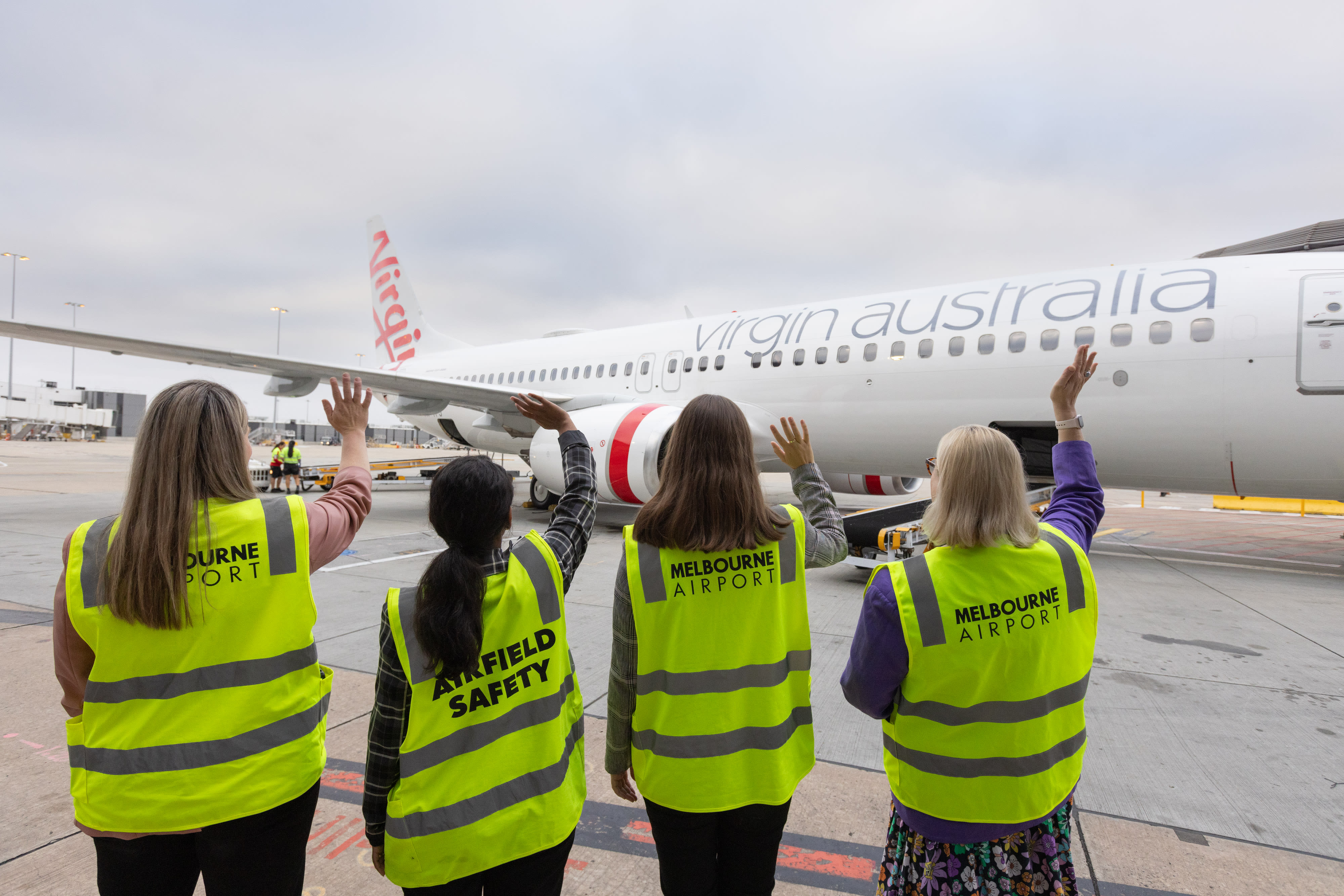 Aviation students waving off Virgin Australia's International Womens Day flight