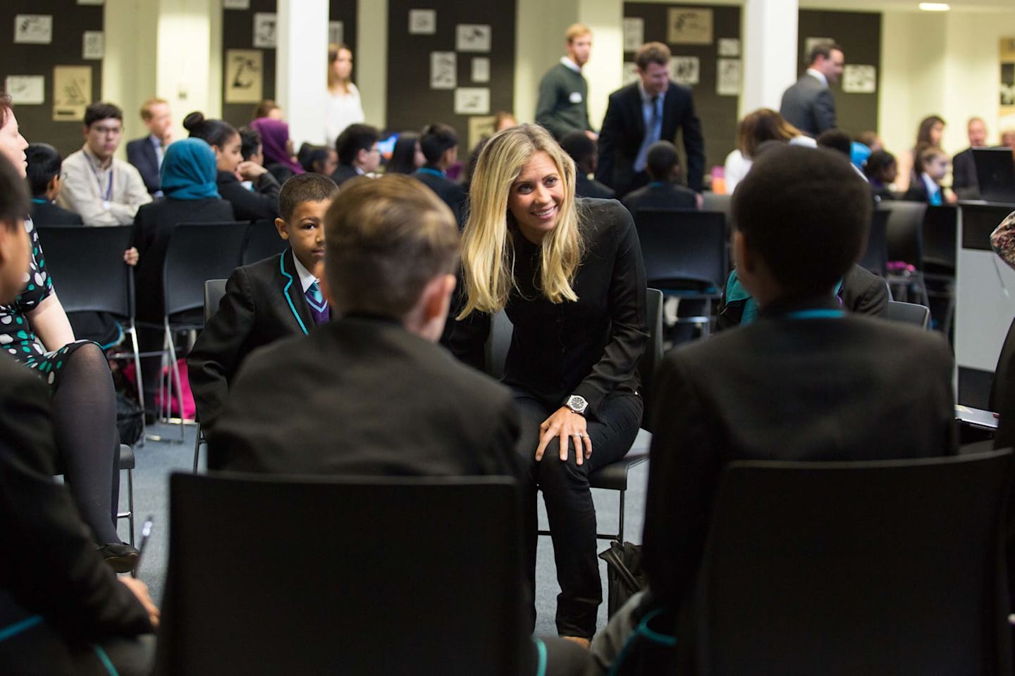 Holly Branson smiling at school children during a Big Change visit