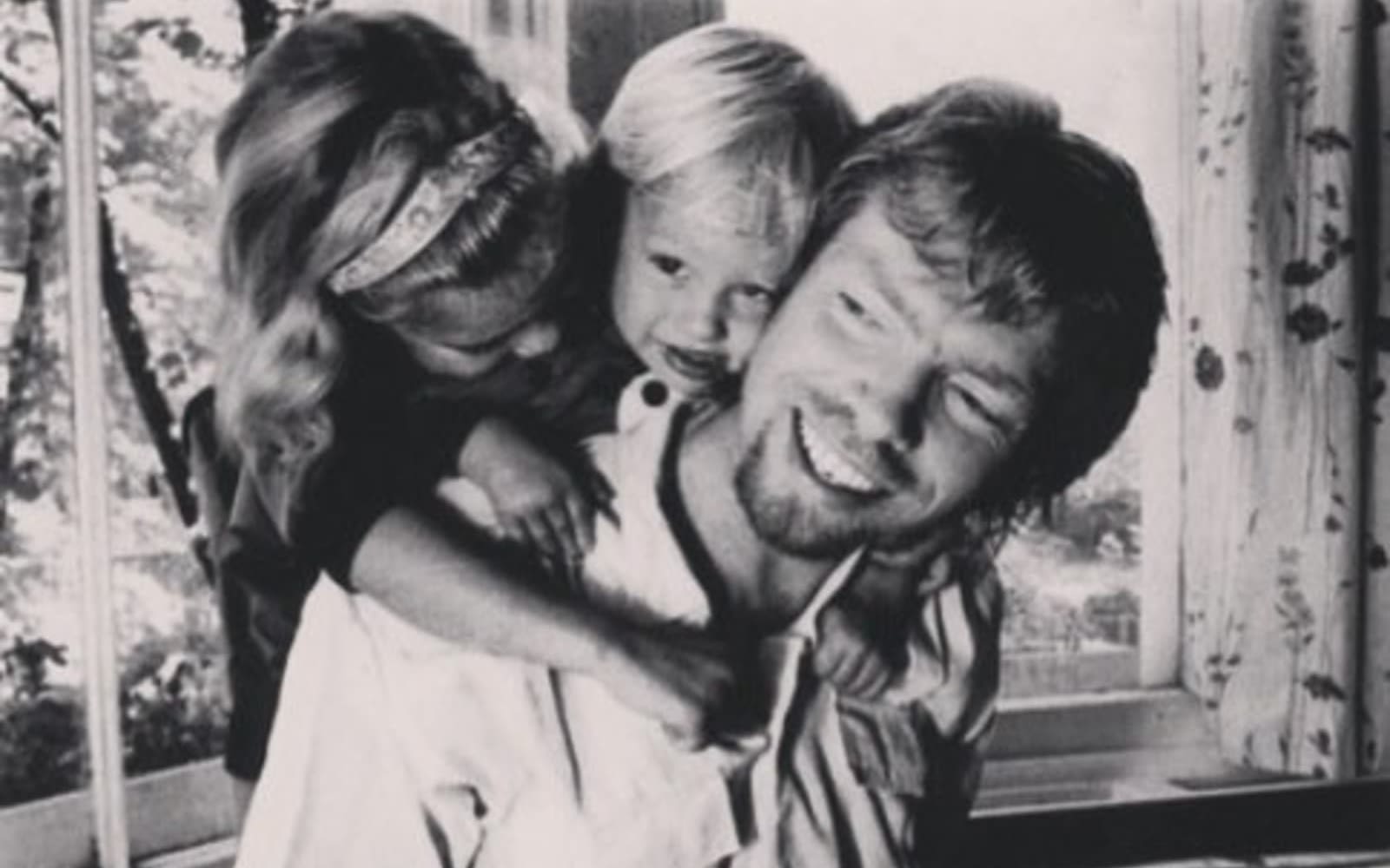 A young Richard Branson with Sam and Holly Branson as children on his back