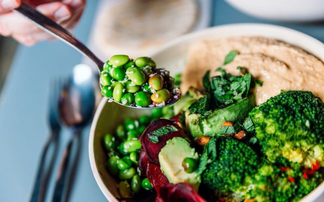 A bowl of vegetables with hummus