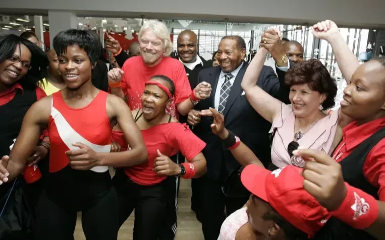 Richard Branson dancing with a group of people in an office