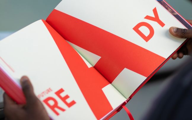 Virgin By Design book opened at a page that says 'Ready' in red lettering