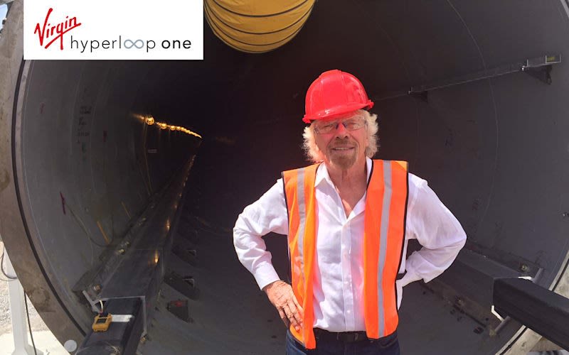 Richard Branson wearing a construction vest and helmet for Hyperloop One