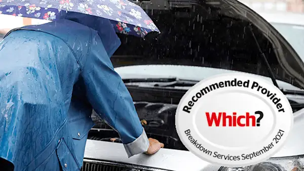 Woman checking her engine in the rain.