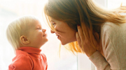 Person smiling at child