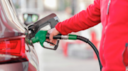 Person filling up a car with petrol