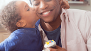 Young son kissing dad on cheek