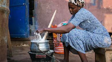 Woman using a gyapa stove