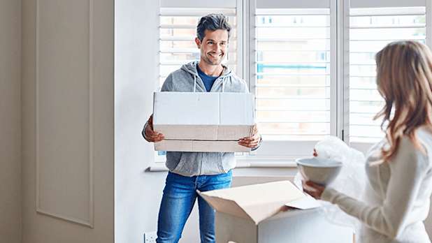 A couple unpacking boxes in new house