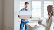 A couple unpacking boxes in new house