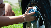 Hand cleaning car wheels with sponge