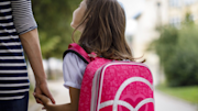 Mother and daughter walking to school