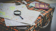 Suitcase with map and passport on top