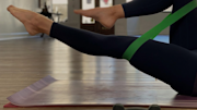 Person stretching their leg with an exercise band