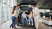 Family in a car showroom buying a car