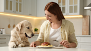 woman and dog at table
