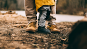 Two people standing in the woods
