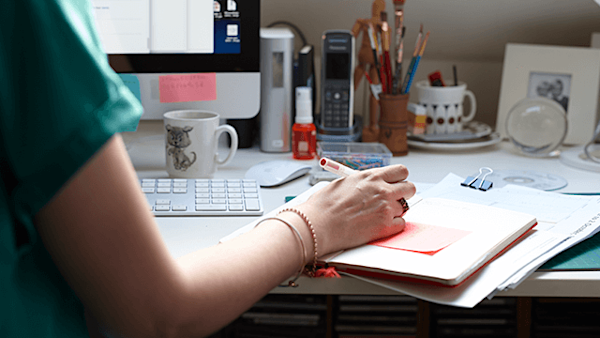 Making notes on the side of a desk.