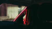woman with red hair sitting in car